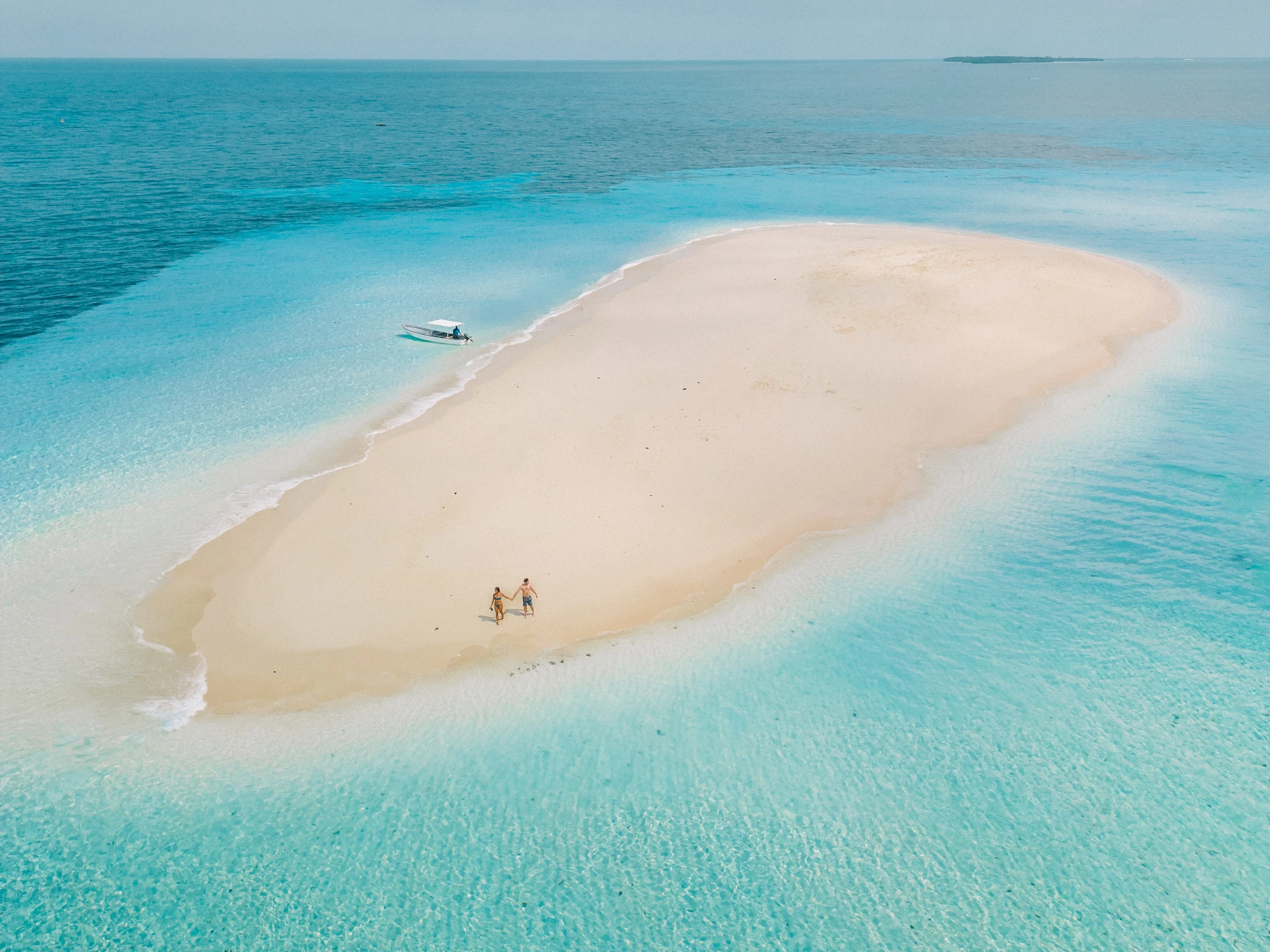A small sandbank surrounded by clear turquoise water off Zanzibar