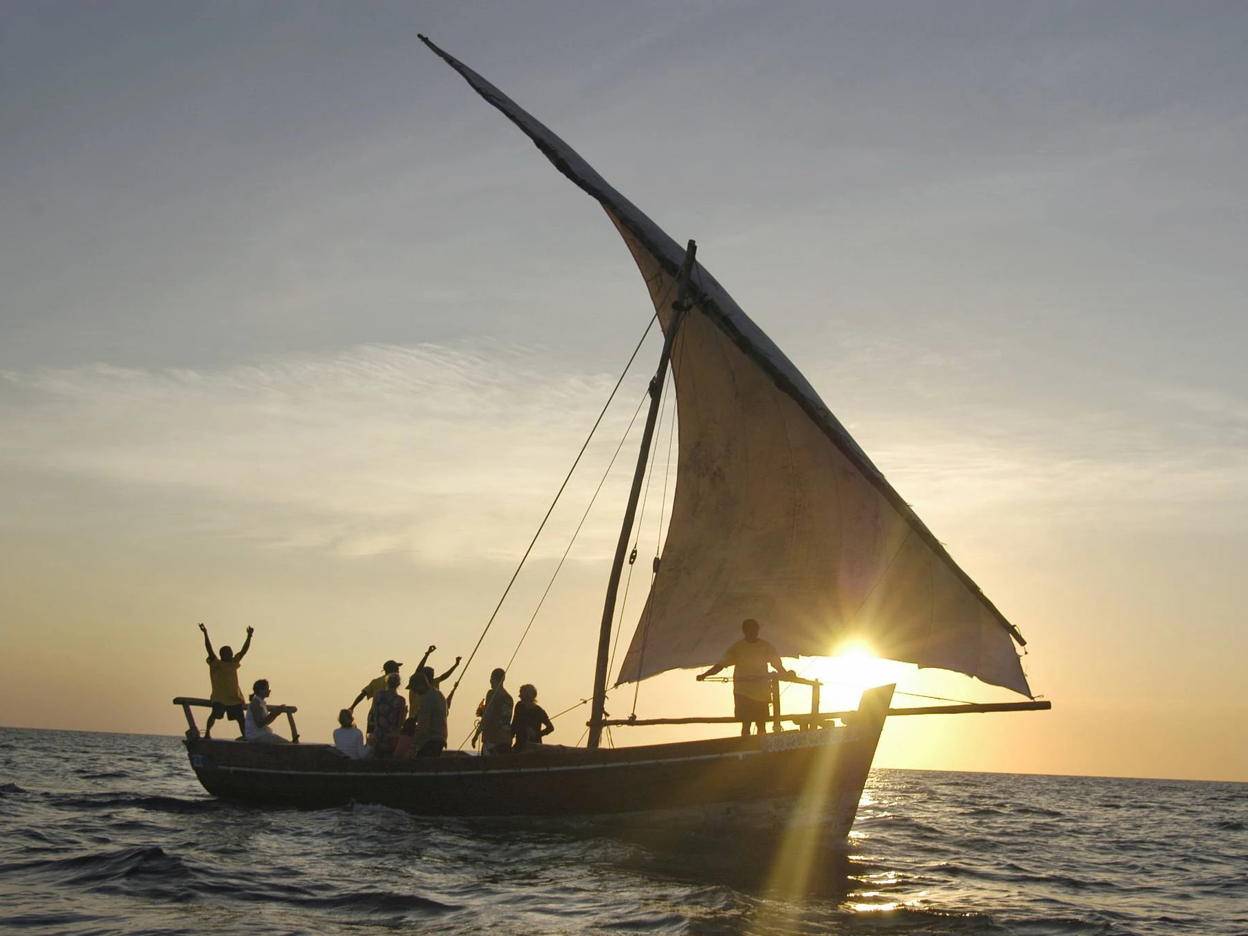 A traditional dhow sailing at sunset off Zanzibar